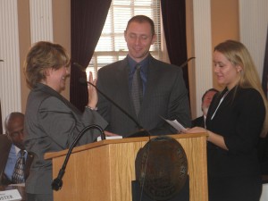 Peekskill Mayor Mary Foster being sworn-in by her son and daughter.