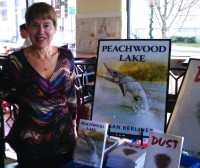 Susan Berliner and her books “Peachwood Lake” and “Dust.”