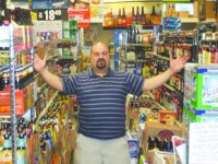 Al Cardullo is pictured down one of the aisles of Beverage World, which is filled with beers from both near and far.