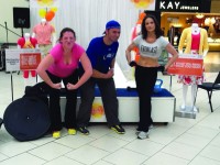 Mom's NIte Out All-Out Fitness owner Neil Denaut gave fitness demonstrations with the help of Danielle Payne (left) and Nicole Katz (right) during the Mom’s NIte Out event at Jefferson Valley Mall.