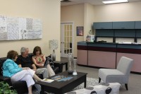 Diane and Bob Arenholz with Susan Labate in the lounge area of the new office in Yorktown. 