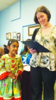 Park School student Siri Reddy receives a reading award from educator Mary Katherine Hillman.