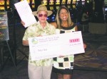 Cortlandt resident Peter Gee poses with Yolanda Vega of the New York State Lottery and his winning  million Lotto check.