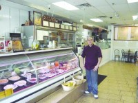 Diego Sarmiento stands proudly in his restaurant.