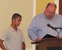 Joshua Nelson (left) was cited for his bravery by Southeast Councilman Robert Cullen (right).