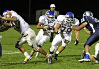 9-25 Mahopac's Andrew Marchionni and Danny Good (79) lead the way for Nick Russo in 21-0 loss to John Jay. | The Examiner News