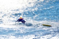 Caren Guyett in action caren Guyett dives into the ocean in Japan with her lifeguard bouy and fins as she swims out to a teammate pretending to be a victim.