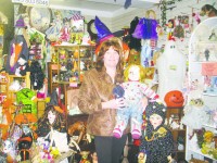 Suzanne kraus-Mancuso poses with a Chuckie doll at enchanted Forest.