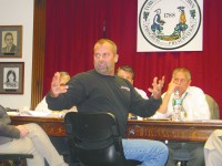 Brian amico, owner of Competition Carting, reacts to hecklers in audience at yorktown town hall.