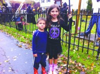 Victoria, 8, and Michael Zumatto, 4, pose in front of Domenic Pizarello’s home in Yorktown Heights featuring scary figures and contraptions, all handmade, designed to delight children and adults.