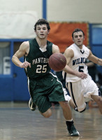 Charlie Montgomery of Pleasantville dribbles the ball up the courtas Westlake's Richie Maio chases during Friday's game. Photo by Andy Jacobs