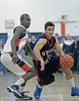 Byram Hills guard Jeff Lynch tries to drive around Greeley's Harrison Brown in Friday's game. Photo by Andy Jacobs