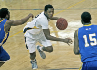 Pace University's Jaylen Mann finds his path to the basket blocked by a pair of New Haven defenders during Sunday night's game. Photo by Andy Jacobs