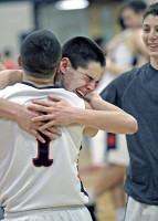 An emotional Brian Skelly hugs teammate Justin Pollack after the Bobcats' miraculous playoff victory Friday. Photo by Andy Jacobs