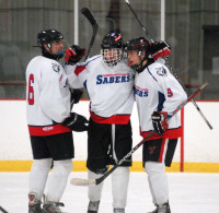 Somers/NS stud Mitch Lanyi (middle) celebrates his goal with Noah Hale (L) and Alex Sheehy (R) in the Sabers’ 6-2 win over Carmel Friday night at the BIA. Photo by Ray Gallagher 