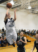 Putnam Valley junior G Zach Coleman goes above the rim to dazzle a pair of Pleasantville defenders with a choice alley-oop hoop, part of a 14-2 fourth-quarter run in the Tigers' come-from-behind 41-38 win over the visiting Panthers last Wednesday.. Photo by Ray Gallagher