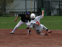 On a controversial umpire’s call in the sixth inning of the White Plains versus New Rochelle game on Thursday. The Tigers scored four runs after Kyle Adams (sliding) was called safe stealing second, which would have been the third out of the inning. Huguenots shortstop John Valente (left) has the ball in his glove, while Adams hook-slides into second base. Tigers won 5-1.  Photo by Albert Coqueran