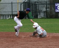 Huguenots shortstop John Valente (left) thinks he made the tag and bring his glove up as Adams hook-slides into second base on the steal attempt in the sixth inning. Photo by Albert Coqueran 