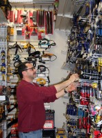 Hardware Manager Mike Palley checks on some items in the newly opened hardware  store.