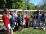 Members of the Pleasantville community, including many high school students, get ready to cut the ribbon on the school's new edible garden last week.