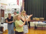 Pleasantville Board of Education President Lois Winkler, foreground, and Superintendent Mary Fox-Alter applauded the budget results Tuesday night.