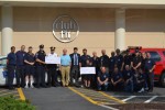 Cardiologist Dr. Frank Zimmerman presents 0 checks to members of the Mount Pleasant Police Department and Millwood Fire Department for winning the Chief's Challenge, an exercise competition.