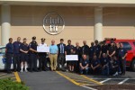 303 Club Fit Challenge pic 2 | The Examiner News Cardiologist Dr. Frank Zimmerman presents 0 checks to members of the Mount Pleasant Police Department and Millwood Fire Department for winning the Chief's Challenge, an exercise competition.