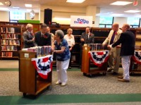 Since no actual ground will be dug and the additions to White Plains Public Library are interior renovations, the ground-breaking ceremony to kick off Phase 1 of the project engaged library staff, board members and financial donors, who moved carts of books to allow the new construction to begin.