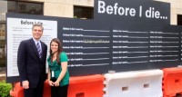 White Plains Mayor Tom Roach and Pamela Del Balzo in front of the inspirational wall at Renaissance Plaza. 