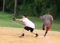 Sports 2 | The Examiner News Green Onions first baseman Dennis Robinson awaits the throw to first base but Lazy Boy’s Greg Catholic burst past the bag for the safe call. Photo by Albert Coqueran