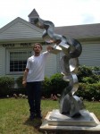 Sculptor Sean Landau with his piece "Why" outside the North Castle Public Library in Armonk.