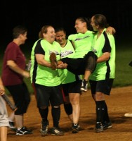 Porter House outfielder Barbara Hennessey is carried off the field by teammates after being injured in the second inning sliding into second base. But all signs show she will be fine for the Women’s League playoffs starting the third week in August. Photo by Albert Coqueran