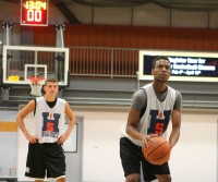 If anyone thinks summer basketball is all fun; look at the intensity on the face of Tigers forward Justin Tapper as he shoots a foul shot and the expression of his Tigers teammate Mike DeMello watching, during a game in the House of Sports Summer League. Photo by Albert Coqueran