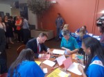 County Executive Rob Astorino and Alisa Kesten, executive director of The Volunteer Center of United Way, join students to write letters to soldiers.