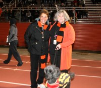 WPHS Athletic Director Jennifer DeSena (left) and Principal Ellen Doherty (right) enjoy the Section 1 Quarterfinal game with the Principal’s dog Ros, on the sideline at White Plains High School. Photo by Albert Coqueran