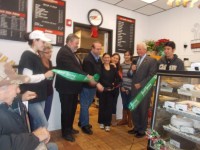Luigi Sinapi, surrounded by his family, Pleasantville Mayor Peter Scherer and Chamber of Commerce President William Flooks at last Friday's ceremonial ribbon cutting at Sinapi's Bakery and Cafe.