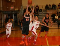 Sleepy Hollow sophomore guard Gabe McGuire (center) tries to swat the ball away form Mamaroneck junior forward Matt Kaufman (#32 center), but the Tigers proved too strong for the Horsemen beating them, 48-37, in the Harry Jefferson Showcase. 