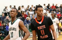 The Woodlands versus White Plains basketball game was settled in the last 30 seconds with the Tigers winning 50-49. Falcons’ guard Jamil Gambari (left) scored 17 points and grabbed 19 rebounds, as Tigers Justin Tapper (right) had four points and 11 rebounds. Photo by Albert Coqueran