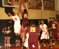 Tigers’ freshman Jordan Tucker (left) makes a gallant effort to defend Knights forward Marquis Henry, who leaps to score his only two points in the game, as Mt. Vernon beat White Plains, 47-49.  Photo by Albert Coqueran