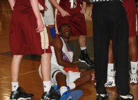 Crusaders forward Demarcus Miller played an outstanding defensive game against Iona Prep on Friday. After fighting for the basketball on the court with two Gaels defenders, he eyes the referee for the jump ball. Photo by Albert Coqueran