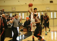 Tigers Jordan Tucker passes under pressure in the White Plains vs. Spring Valley Section 1 Quarterfinal game. Tucker had 19 points in the game but in the third quarter his two points was the only field goal for White Plains, which led to a 69-66 loss to Spring Valley. Photos by Albert Coqueran