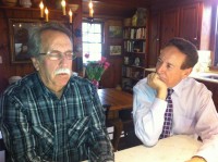 Bob Buchanan, psychic medium, left, in a trance-like state, in the kitchen of The Home Guru, “reading” the visiting spirits. 