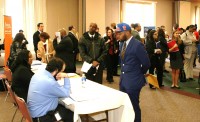 It does not hurt to display your fan affiliation; as Jonathan Brown from Brooklyn, wearing his Knicks cap, has his application reviewed at the Knicks D-League Career Fair at the Westchester County Center, on Tuesday, April 1. Photo by Albert Coqueran