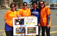 : (From l to r): PTA volunteers Jen DeMilio, Christine Swenson, Wilber David Thomas (student) and Caroline Furry.