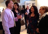 STEAM | The Examiner News : Dr. Yancopoulos (left), with a Regeneron colleague, talks with Patricia Miranda and Janet Langsam (right) during the STEAM Exhibit installation.