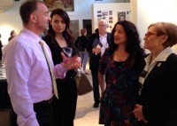 : Dr. Yancopoulos (left), with a Regeneron colleague, talks with Patricia Miranda and Janet Langsam (right) during the STEAM Exhibit installation. 