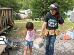 Pleasantville volunteer Rebecca Lord helps a little girl during the recent nine-day trip to repair houses in central Appalachia in West Virginia.