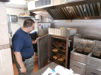 Owner Bob Soto shows off the variety of meats customers can choose from when they stop by.