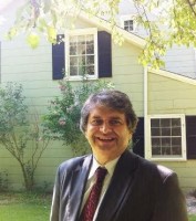 Home improvement “ombudsman” Richard Cirulli stands before the 1861 wing of The Home Guru’s Ebenezer White House to which a modern glass structure will be added. He will mentor the process with contractors.