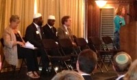 At the podium Cantor Tracey Scher recites a memorial prayer. To the left Rabbi Gordon Tucker, Imam Musa, Abdul Majeed, and Rev. Susan Andrews.